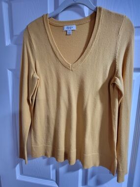 This is a yellow V-neck sweater from Style & Co. It has long sleeves -size Small